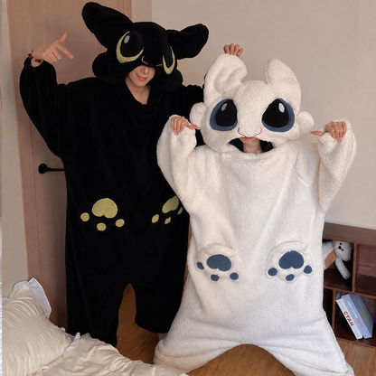 Matching dragon onesies — the black one and the white one